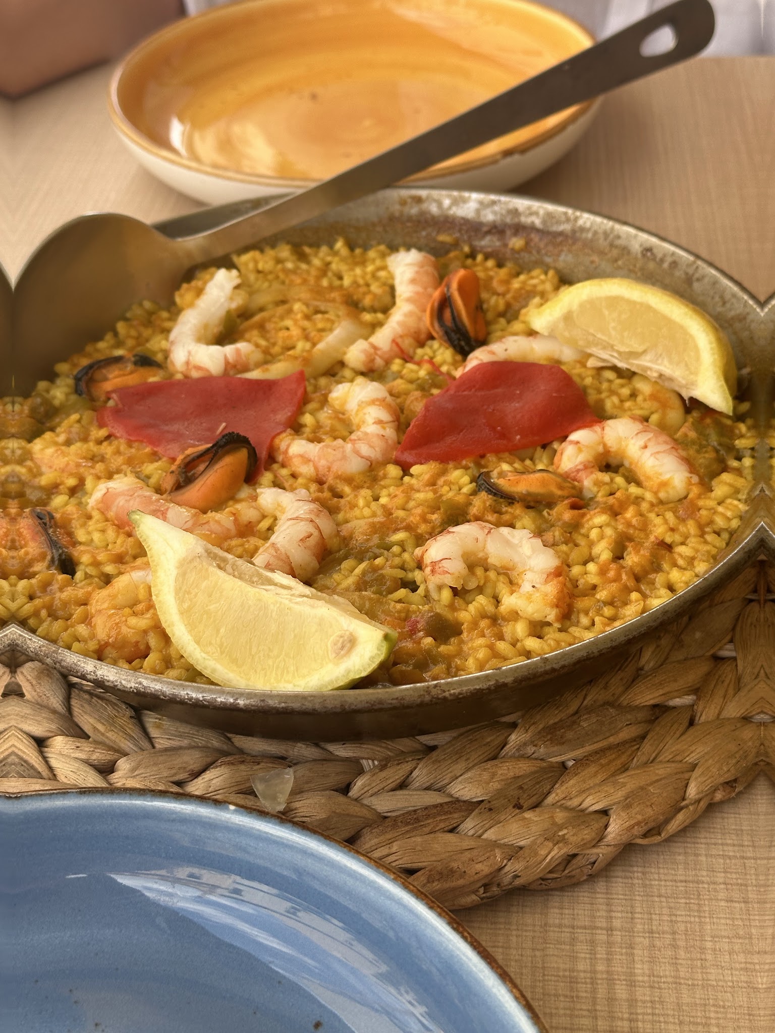 A seafood paella served with prawns, mussels and lemon.